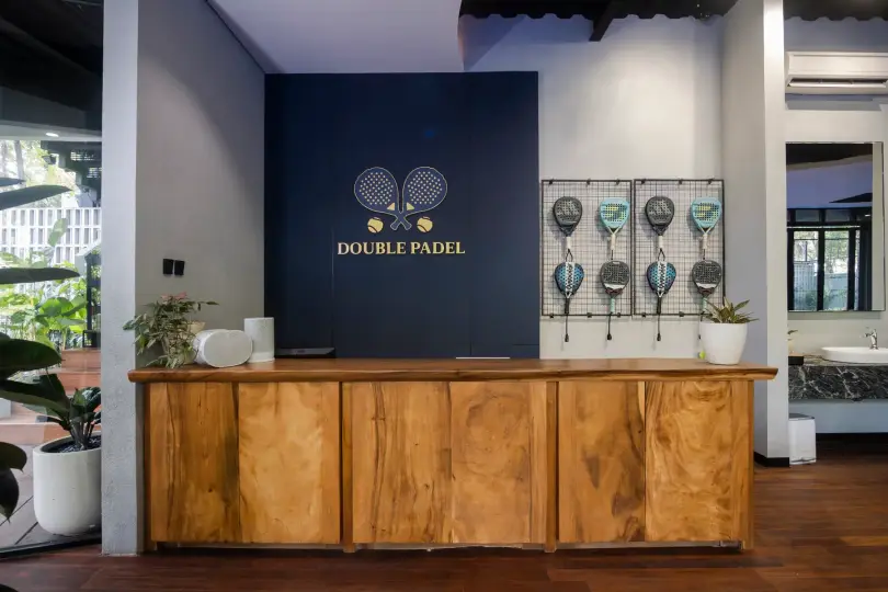 Teak reception counter and racket wall