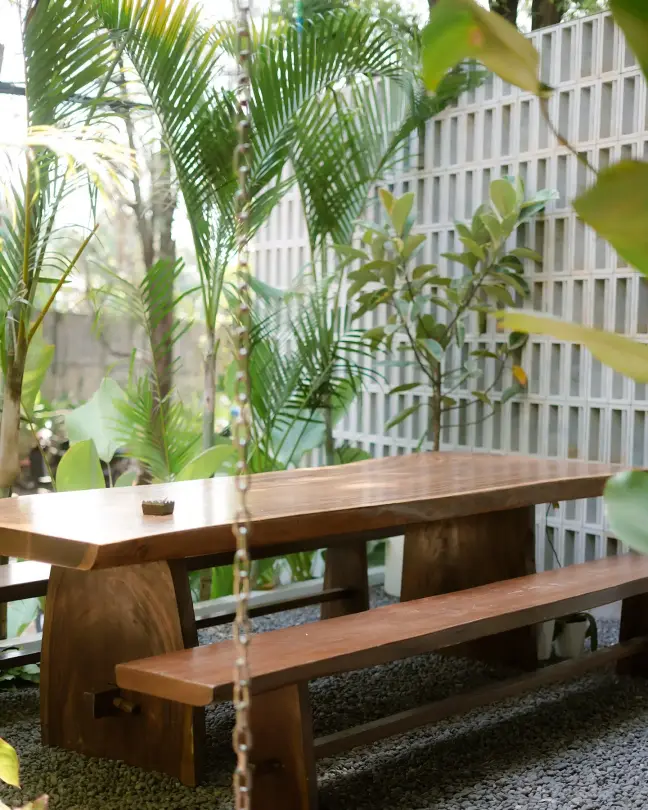 Timber table among palms